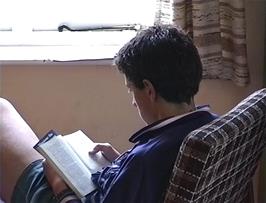 James does some quiet reading in the Kings youth hostel Common Room while we wait for the rain to stop